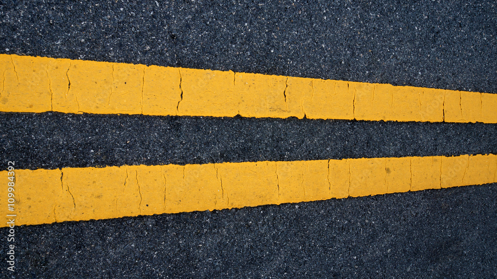 Fototapeta premium Two yellow traffic lines. on thr road.