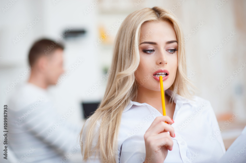Seductive woman holding pencil in her mouth Seductive woman holding pencil in her mouth