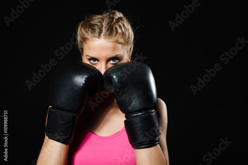 Portrait of beautiful determined woman with boxing gloves.