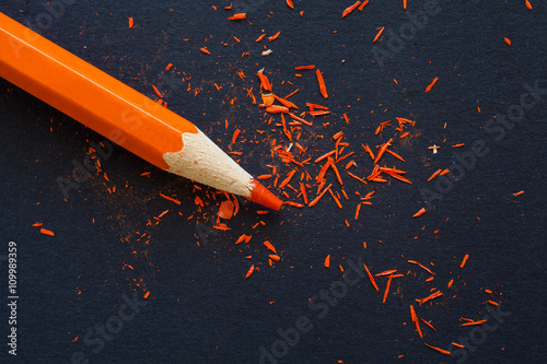 orange pencil shavings on black photo