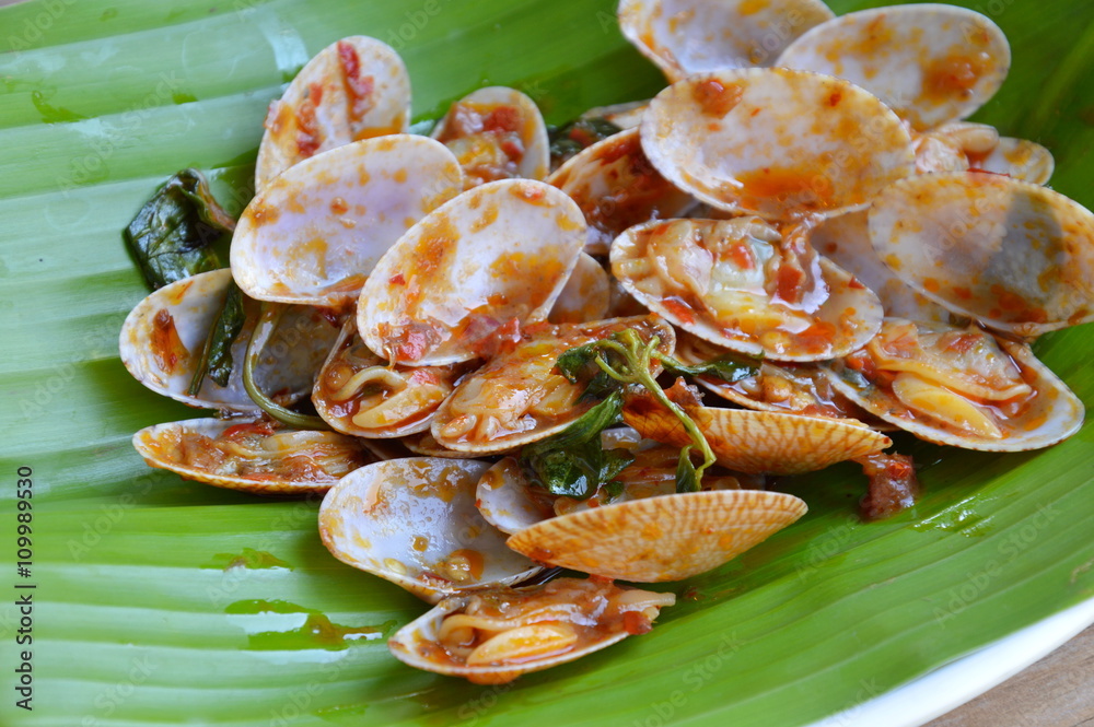 stir fried clams with roasted chili paste on fresh banana leaf stir fried clams with roasted chili paste on fresh banana leaf
