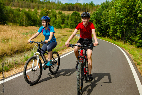 Healthy lifestyle - teenage girl and boy cycling