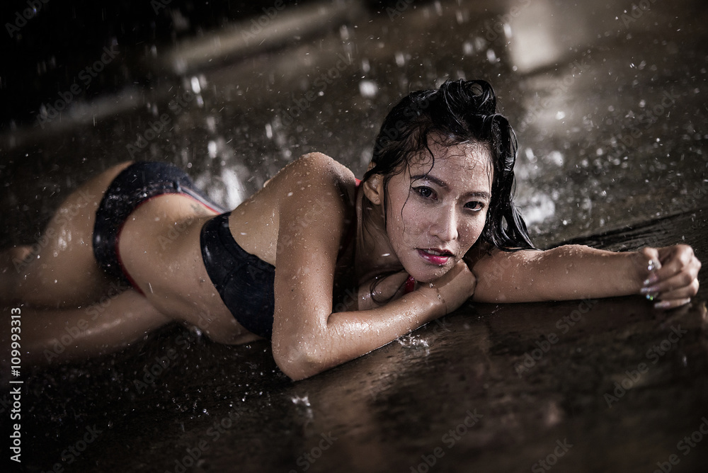 Sexy bikini girl among the rain and water Stock Photo | Adobe Stock