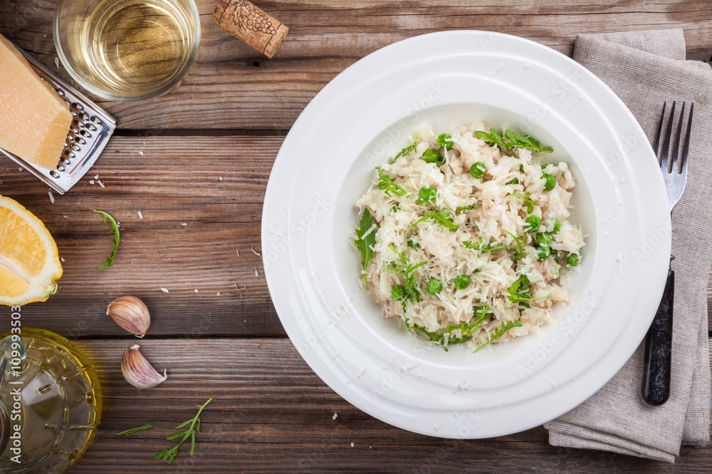 Homemade risotto with chicken, green peas, arugula and parmesan Homemade risotto with chicken, green peas, arugula and parmesan