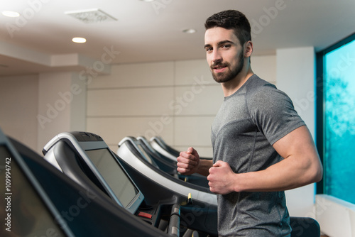 Young Man Exercising On A Treadmill