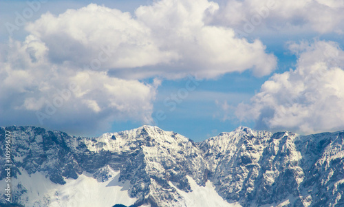 Mountain peaks snow and clouds background