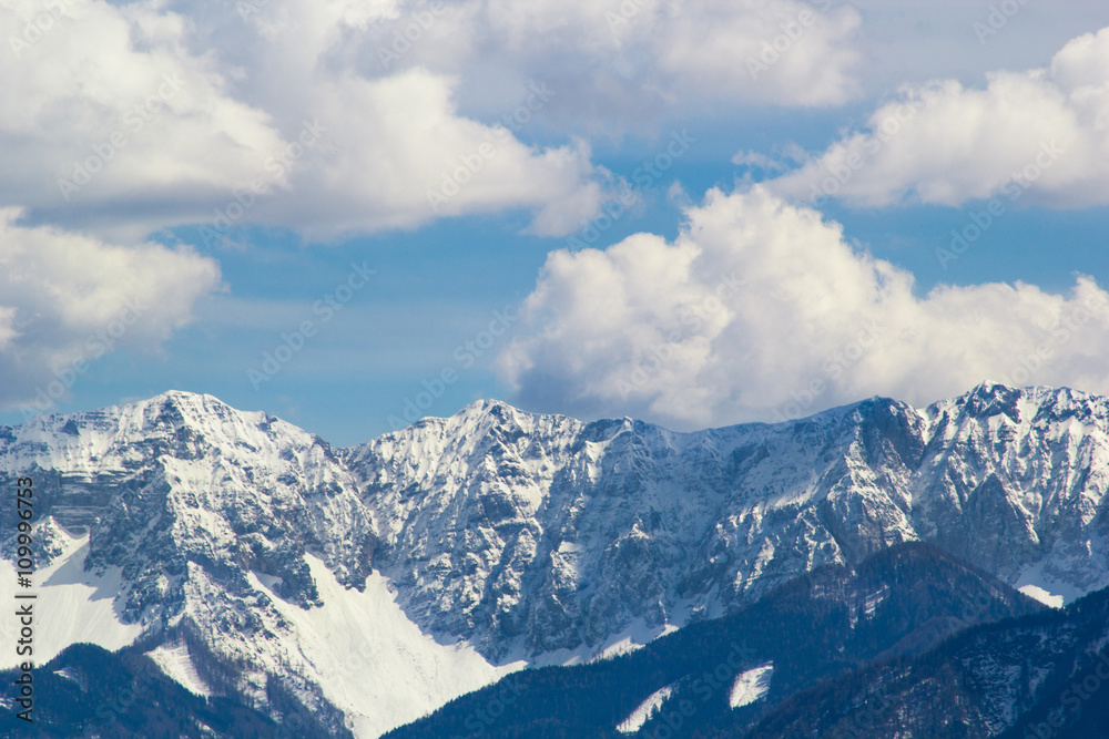 Mountain peaks snow and clouds background