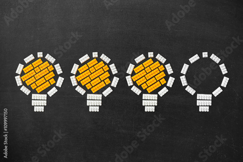 Ideas Light Bulb Concept Work on Blackboard photo