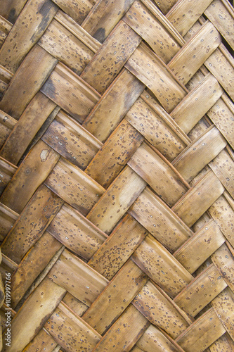 Texture of interweaving brown palm leaves