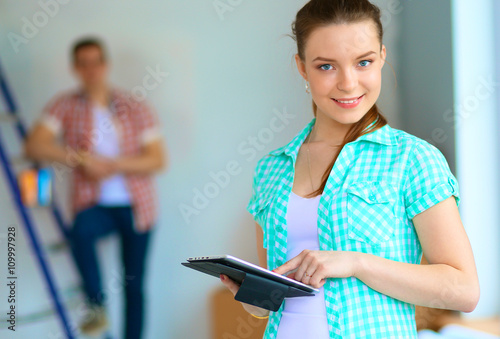 Portrait of young couple moving in new home