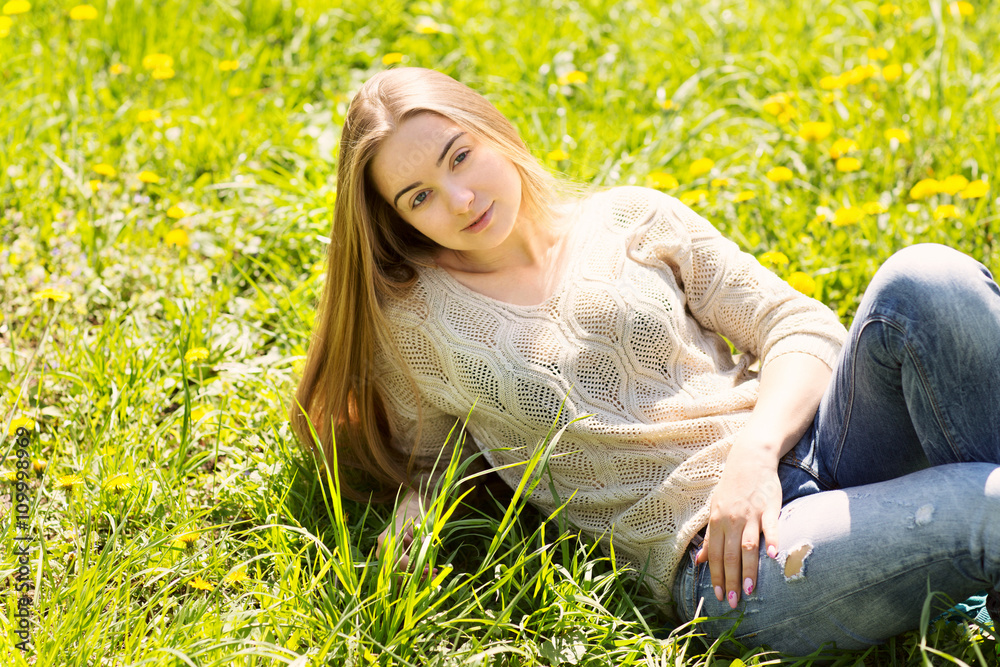 the beautiful young woman with long hair sits on a flower glade in park
the beautiful young woman with long hair sits on a flower glade in park