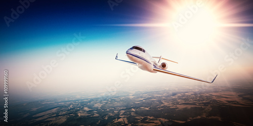 Realistic photo of white generic design private Jet flying over the mountains. Empty blue sky with sun at background.Business Travel by modern Luxury Plane.Horizontal.Closeup photo. 3d rendering