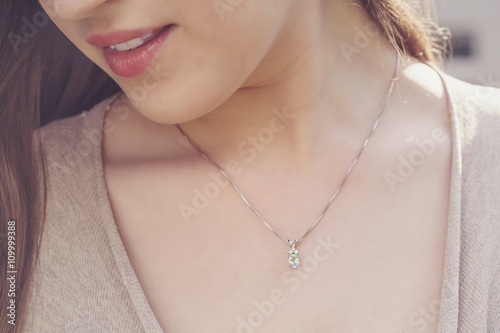 Detal of woman wearing a luxury pendant Fototapeta