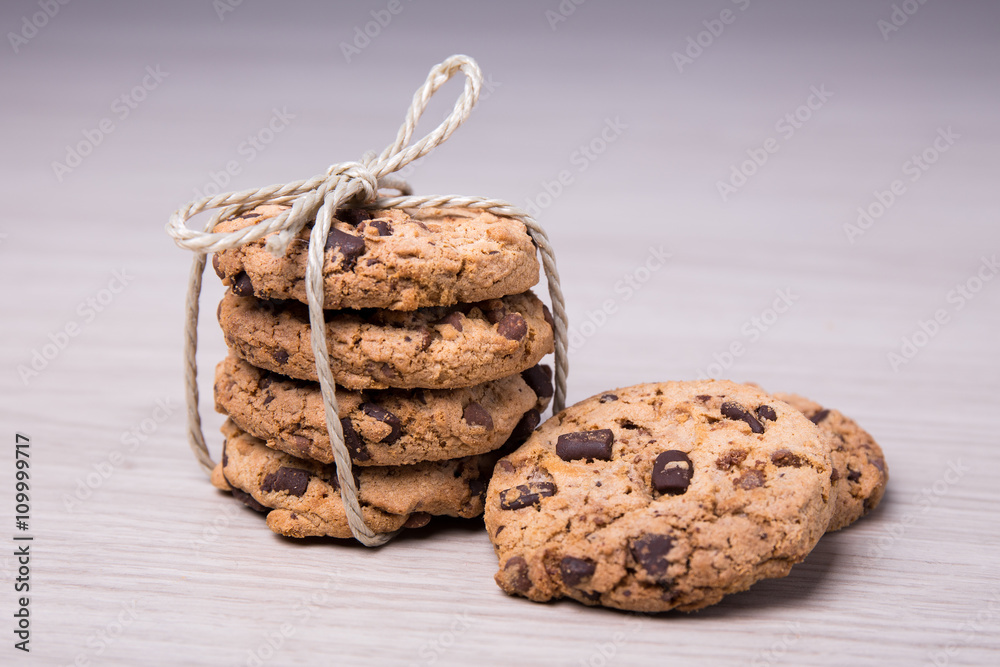 close up of freshly baked chocolate chip cookies on wooden backg close up of freshly baked chocolate chip cookies on wooden backg