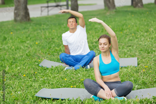 Having yoga practice in park © Sergey Nivens