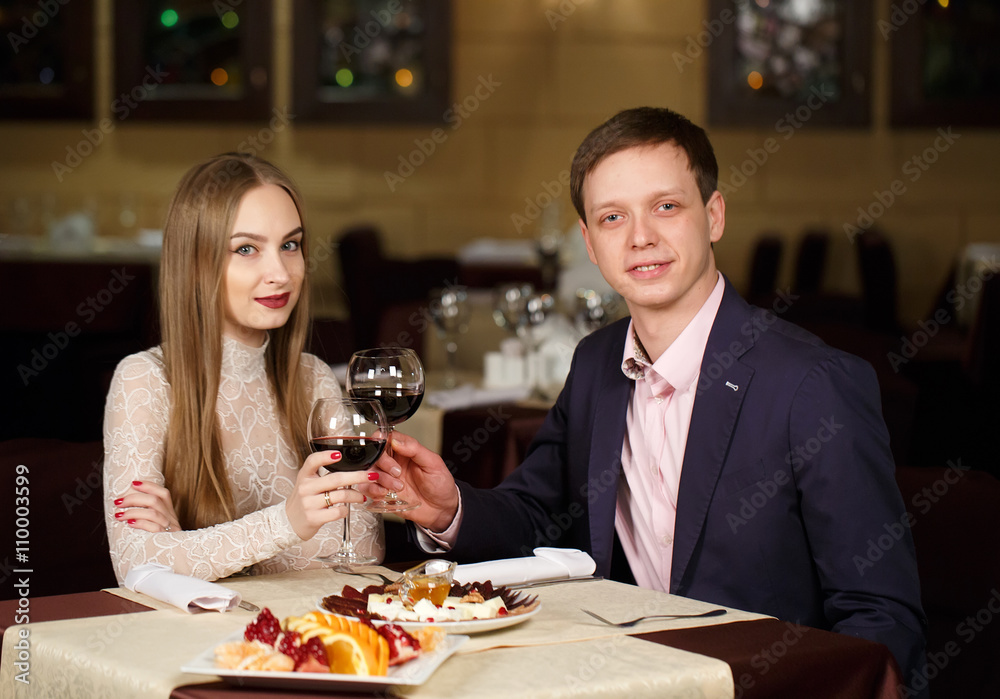 Couple toasting wineglasses in a luxury restaurant. Couple toasting wineglasses in a luxury restaurant.
