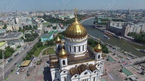 Unique aerial view of Cathedral of Christ the Savior in Moscow city. Russia. Helicopter approach and close flight near. Kremlin at background. Sunny day.