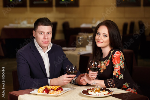 Couple toasting wineglasses in a luxury restaurant