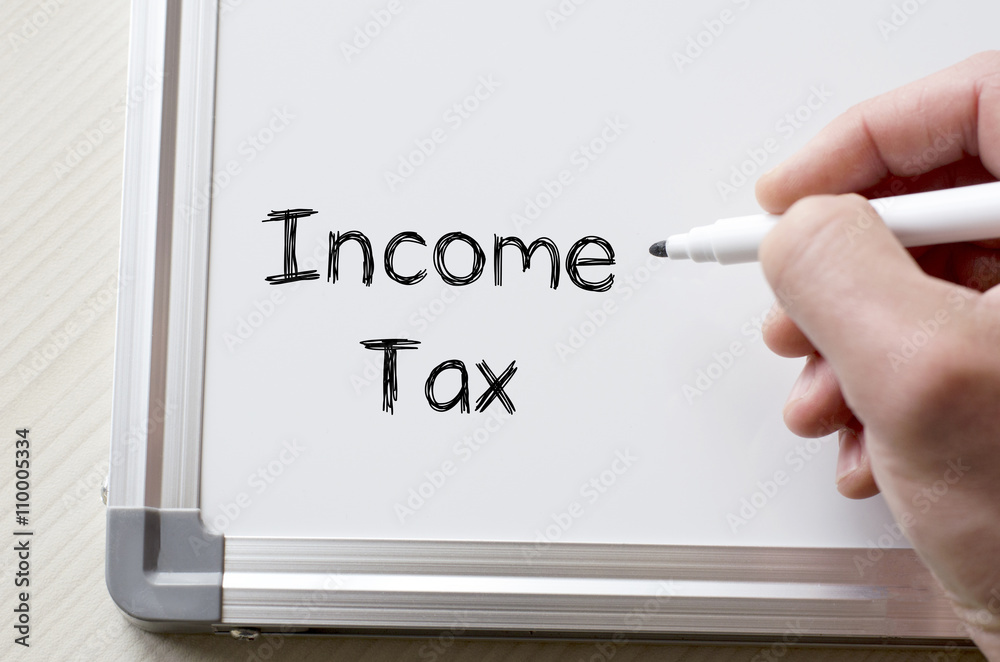 Income tax written on whiteboard Income tax written on whiteboard