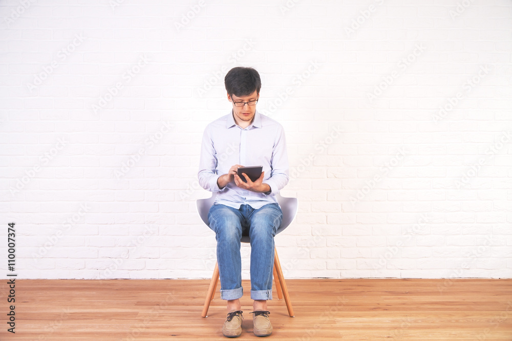 Man using tablet empty interior Man using tablet empty interior