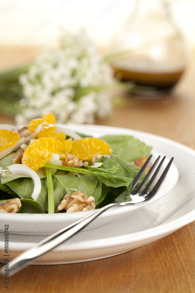 a plate of vegetable salad with slice oranges a plate of vegetable salad with slice oranges