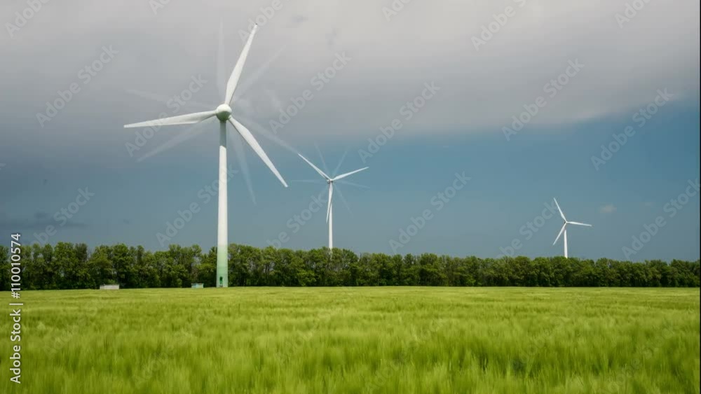4k Wind turbines generating electricity in a green field of barley 4k Wind turbines generating electricity in a green field of barley