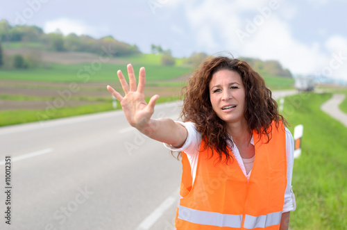 Frantic young woman trying to stop traffic