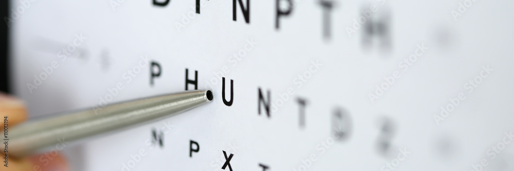 Silver ballpoint pen pointing to letter in eyesight check table - obrazy, fototapety, plakaty 