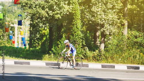 Wallpaper Mural Female cyclist rides a racing bike on road Torontodigital.ca
