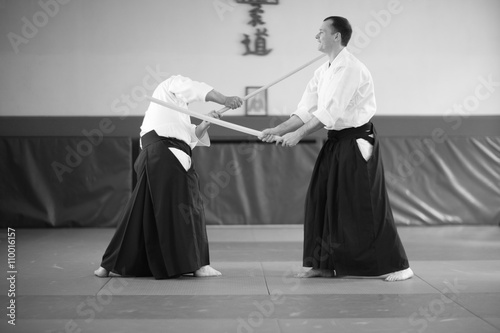 Aikido training full of fun; sensei demonstraing common mistakes in his student technique