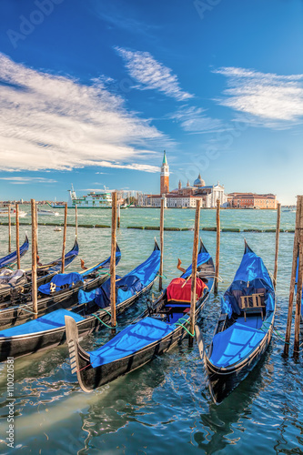 Gondolas against San Giorgio island in Venice, Italy photo