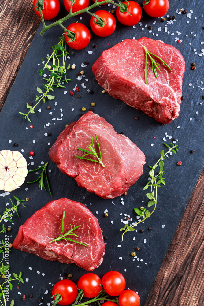 Fresh Raw Beef steak Mignon, with salt, peppercorns, thyme, garlic. Fresh Raw Beef steak Mignon, with salt, peppercorns, thyme, garlic.