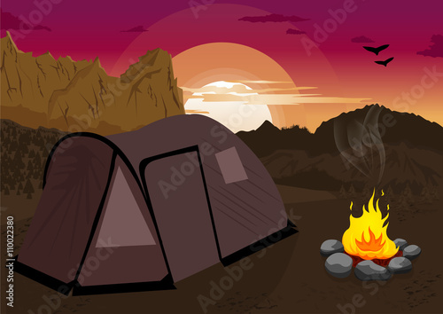 Mountain landscape at sunset with camping tent and campfire 