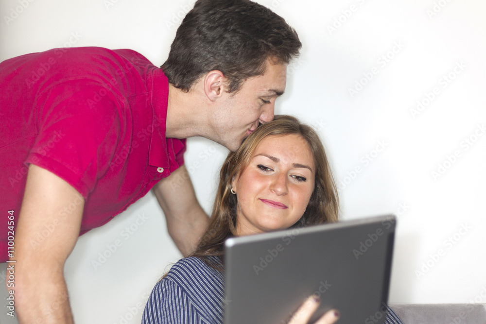 Young couple watching digital tablet at home Young couple watching digital tablet at home