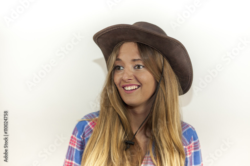 Portrait of beautiful blonde woman with plaid shirt and a cowboy