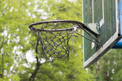 Old basketball hoop in the city park in rainy day.