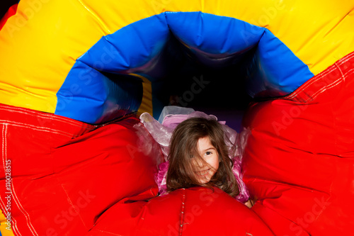 Little Girl Crawling Through Inflatable