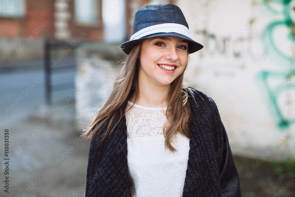 Portrait of a stylish and beautiful teenager girl in the hat. She posing and smiling. Portrait of a stylish and beautiful teenager girl in the hat. She posing and smiling.