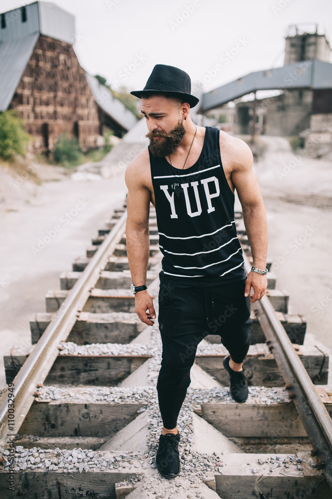 Stylish and fashionable bearded man posing on a outdoor Stylish and fashionable bearded man posing on a outdoor