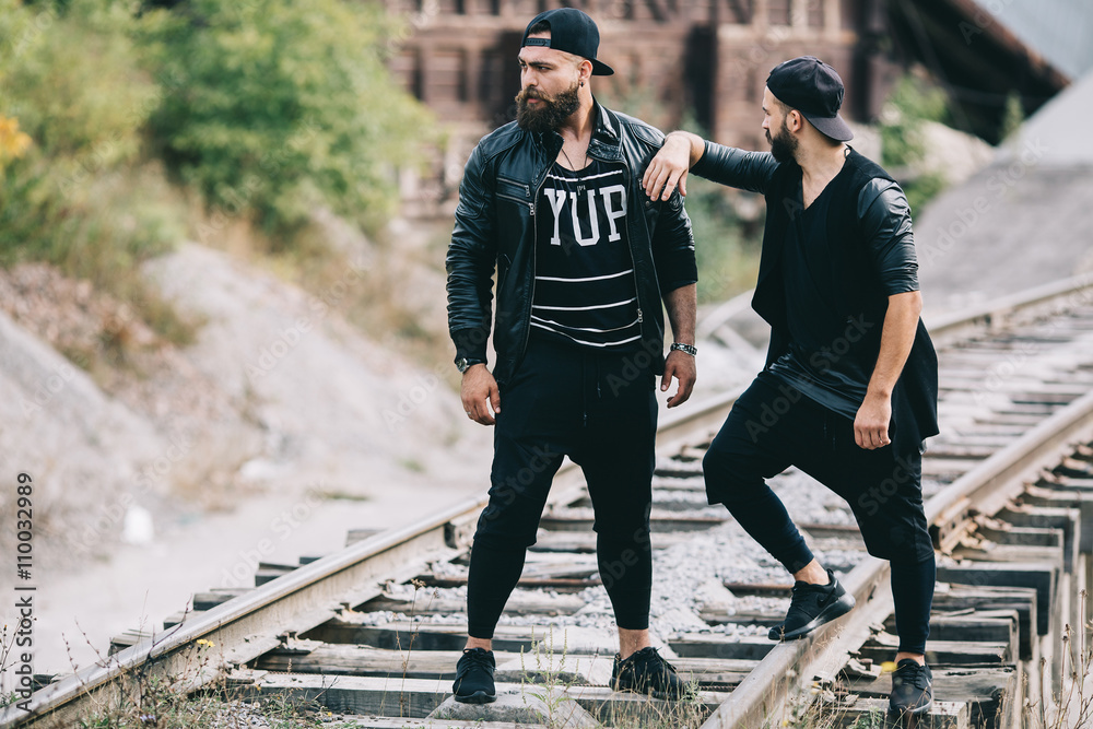 Fototapeta premium Two bearded men posing on a industrial zone
