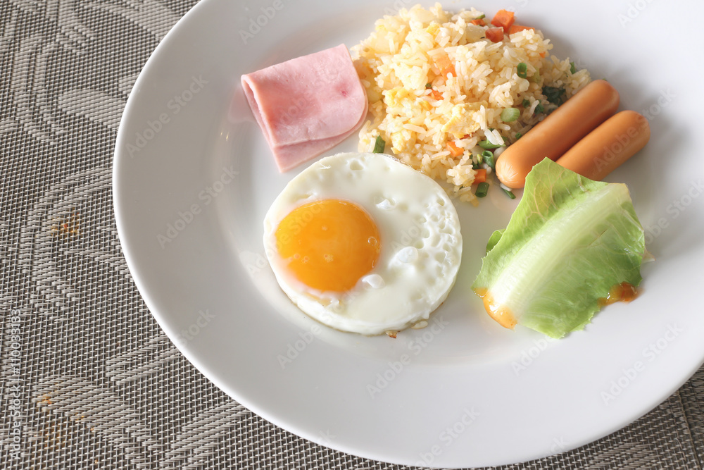 Breakfast with fried rice and fried egg in a white dish. Breakfast with fried rice and fried egg in a white dish.