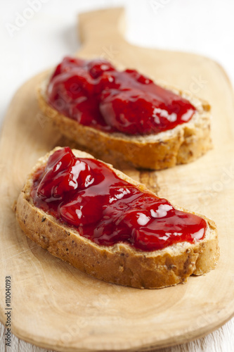 two slices of bread with strawberry jam