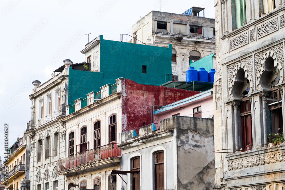 HAVANA - APRIL 27: People, cars and buildings in Old Havana (Havana Vieja), Havana, Cuba on April 28, 2016