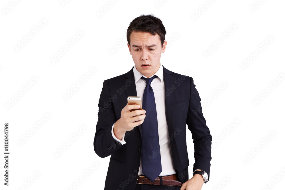Young Caucasian business man frowning looking at mobile phone Young Caucasian business man frowning looking at mobile phone
