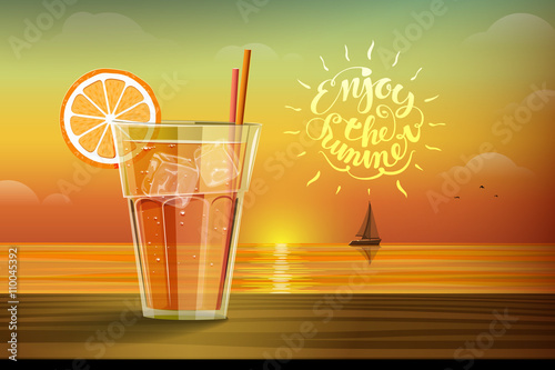 Glass with lemonad at sunset