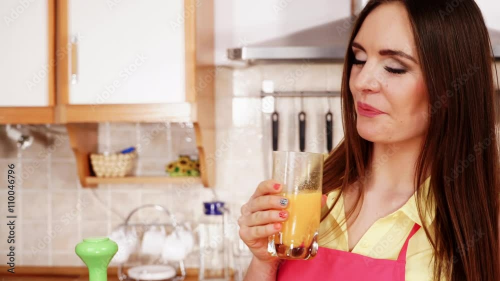 Woman in kitchen drinking fresh orange juice 4K Woman in kitchen drinking fresh orange juice 4K