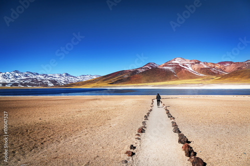 Tourist enjoying the beautiful landscape of Atacama Desert in Chile. Winter time. photo