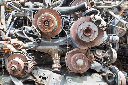 Heaps of used old auto vehicle disk and drum brake parts for reclycle at workshop photo