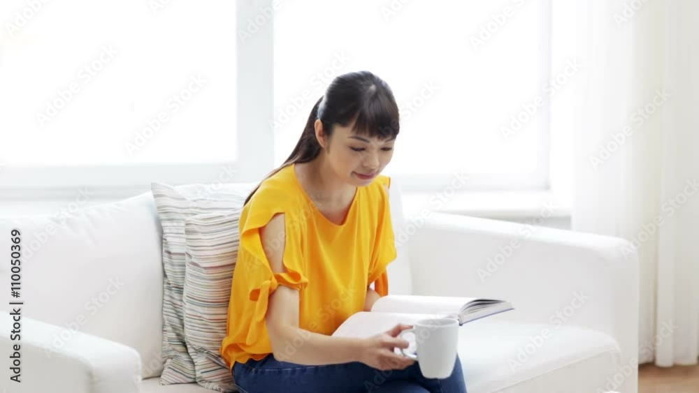smiling young asian woman reading book at home smiling young asian woman reading book at home