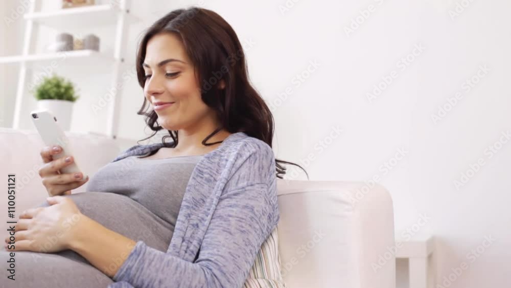 happy pregnant woman with smartphone at home happy pregnant woman with smartphone at home
